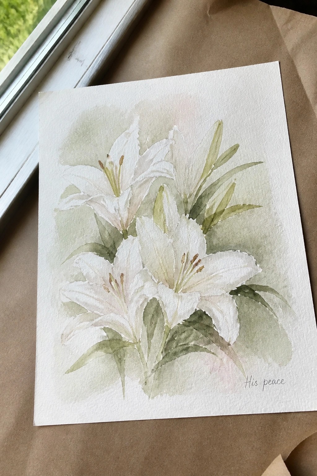 Watercolor painting of white lilies with green leaves on paper, labeled 