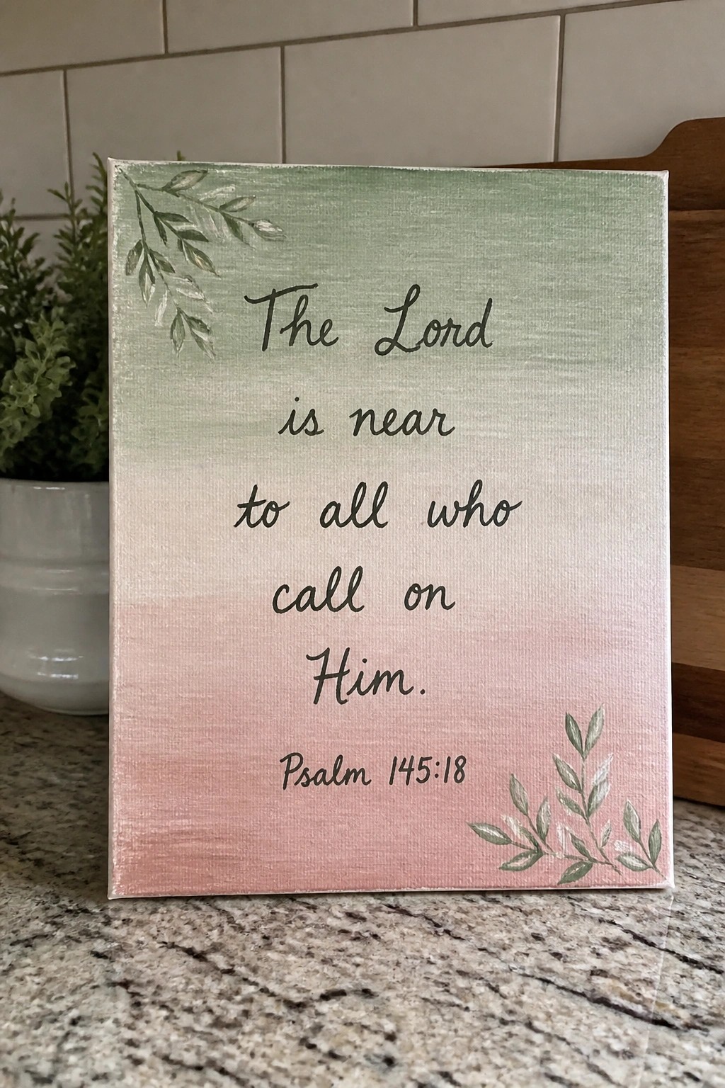 Green-pink gradient canvas sign with Psalm 145:18 verse and leafy corner accents
