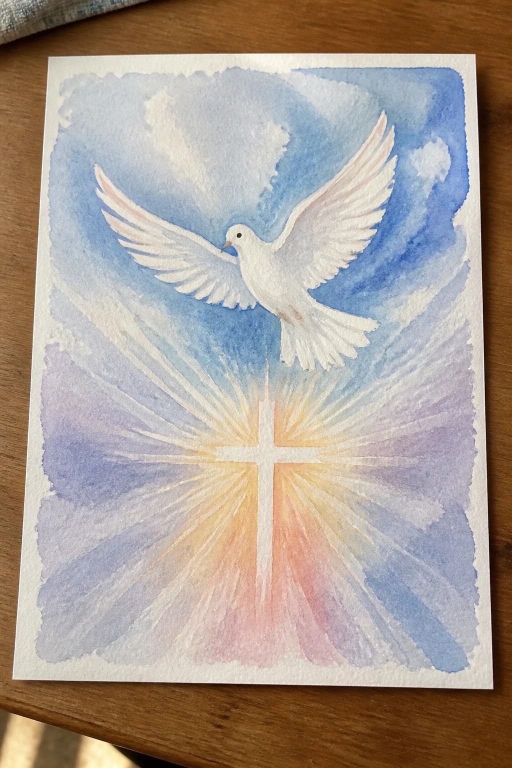Watercolor painting of white dove flying above glowing cross with radiant light beams.