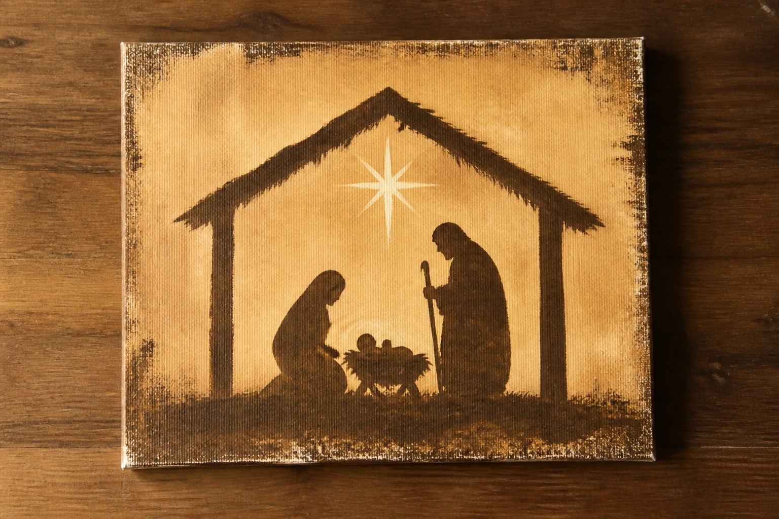 Sepia canvas painting of nativity: Mary kneeling, Joseph with staff, manger under star.