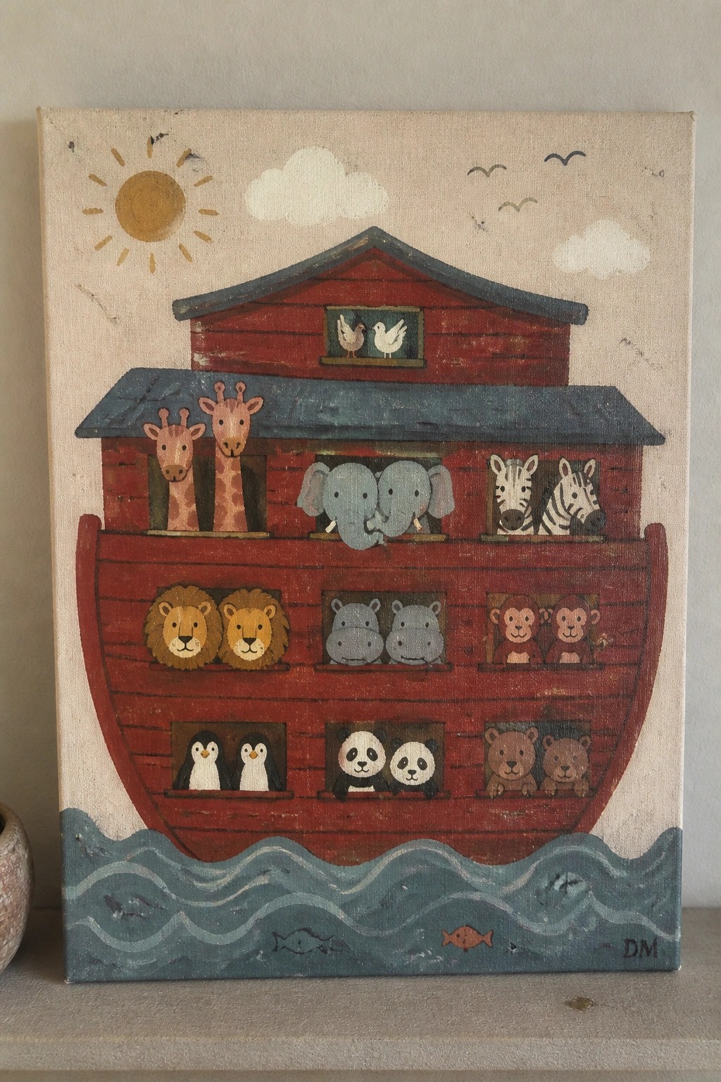Colorful painting of red Noah's Ark with paired animals on blue waves under sun.