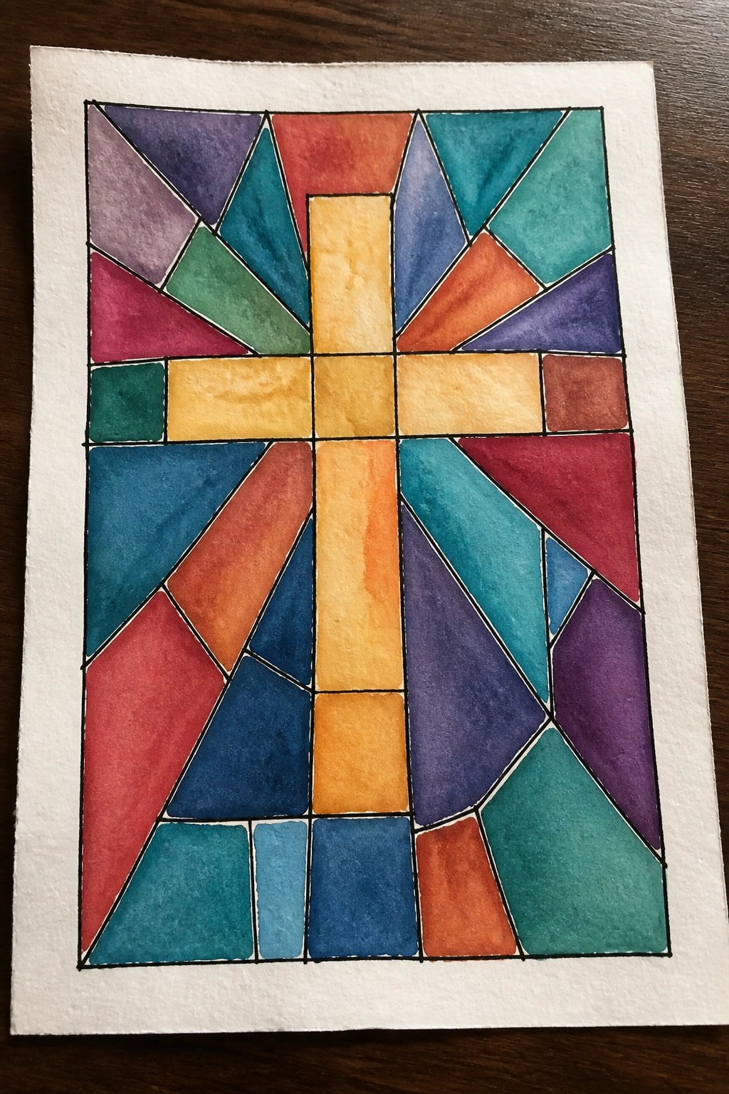 Colorful geometric cross in vibrant watercolor resembling stained glass window design