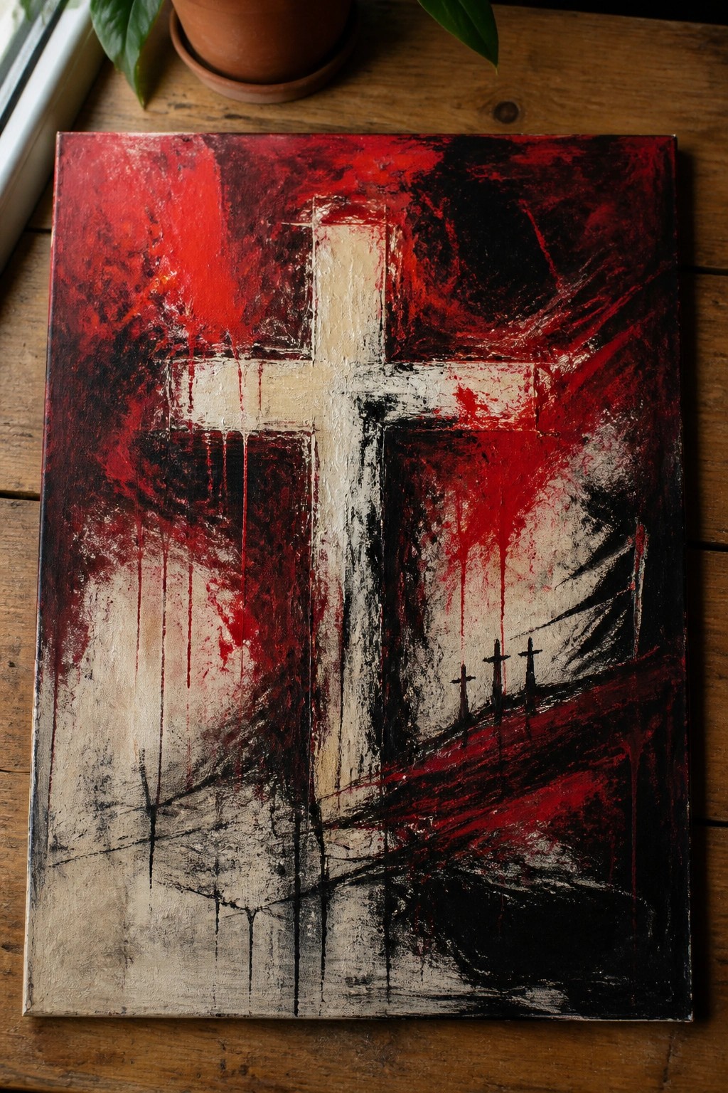 Abstract painting of white cross with red drips and three small crosses on canvas