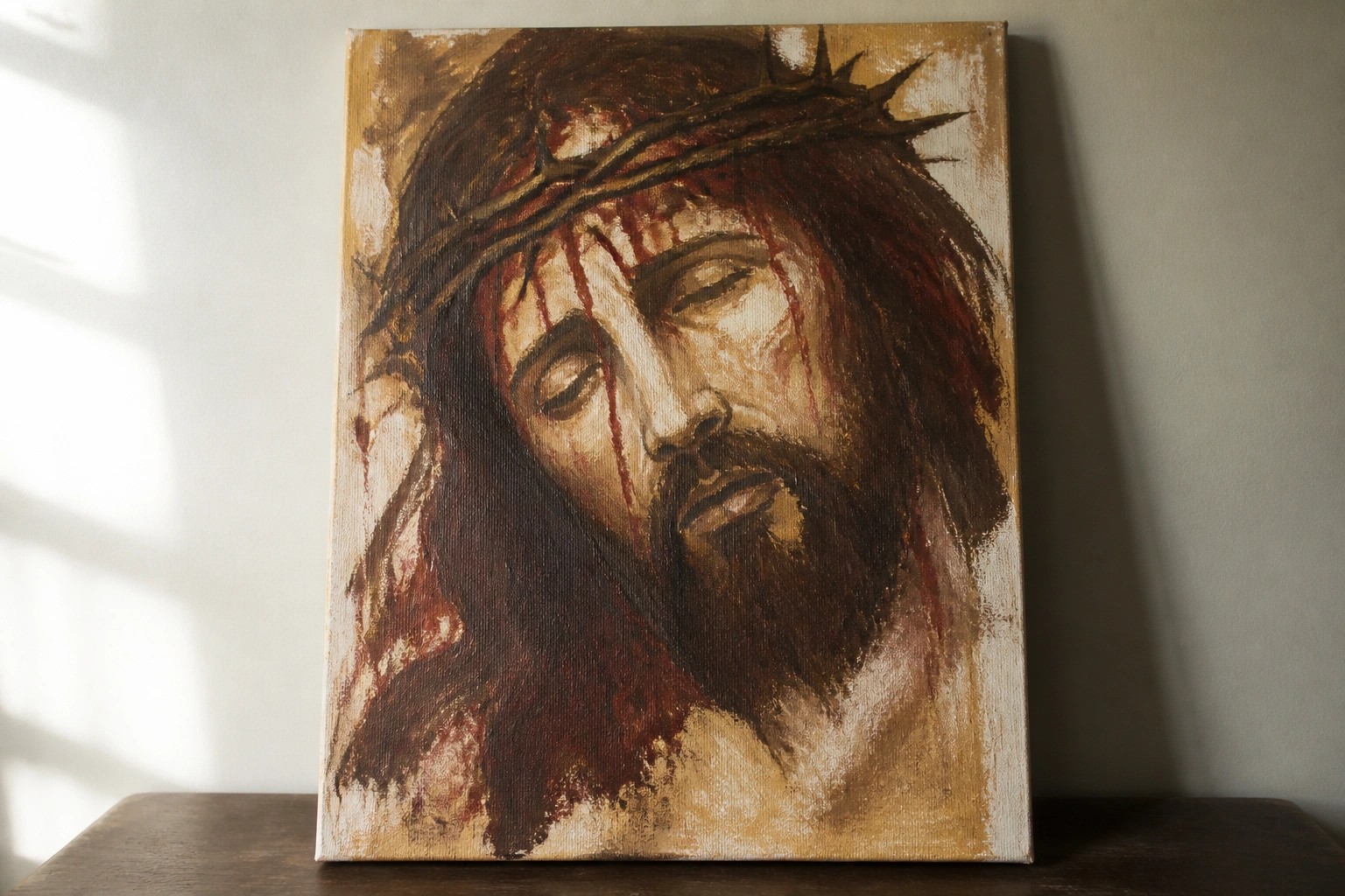 Oil painting of Jesus with crown of thorns, blood streaking his closed-eyed face.