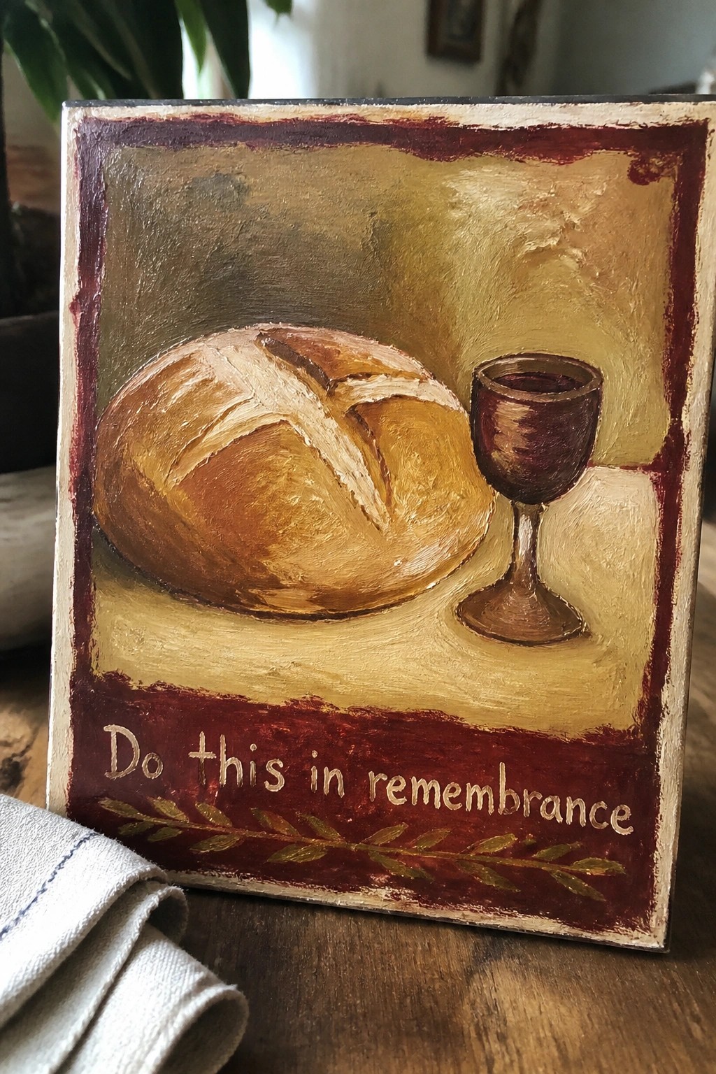 Rustic painting of bread loaf and wine goblet on plaque with remembrance text