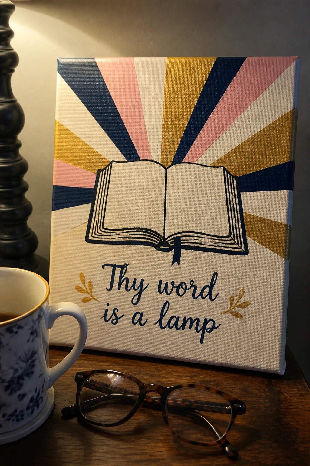 Colorful striped canvas with open book art, quote, glasses, and floral mug on wood