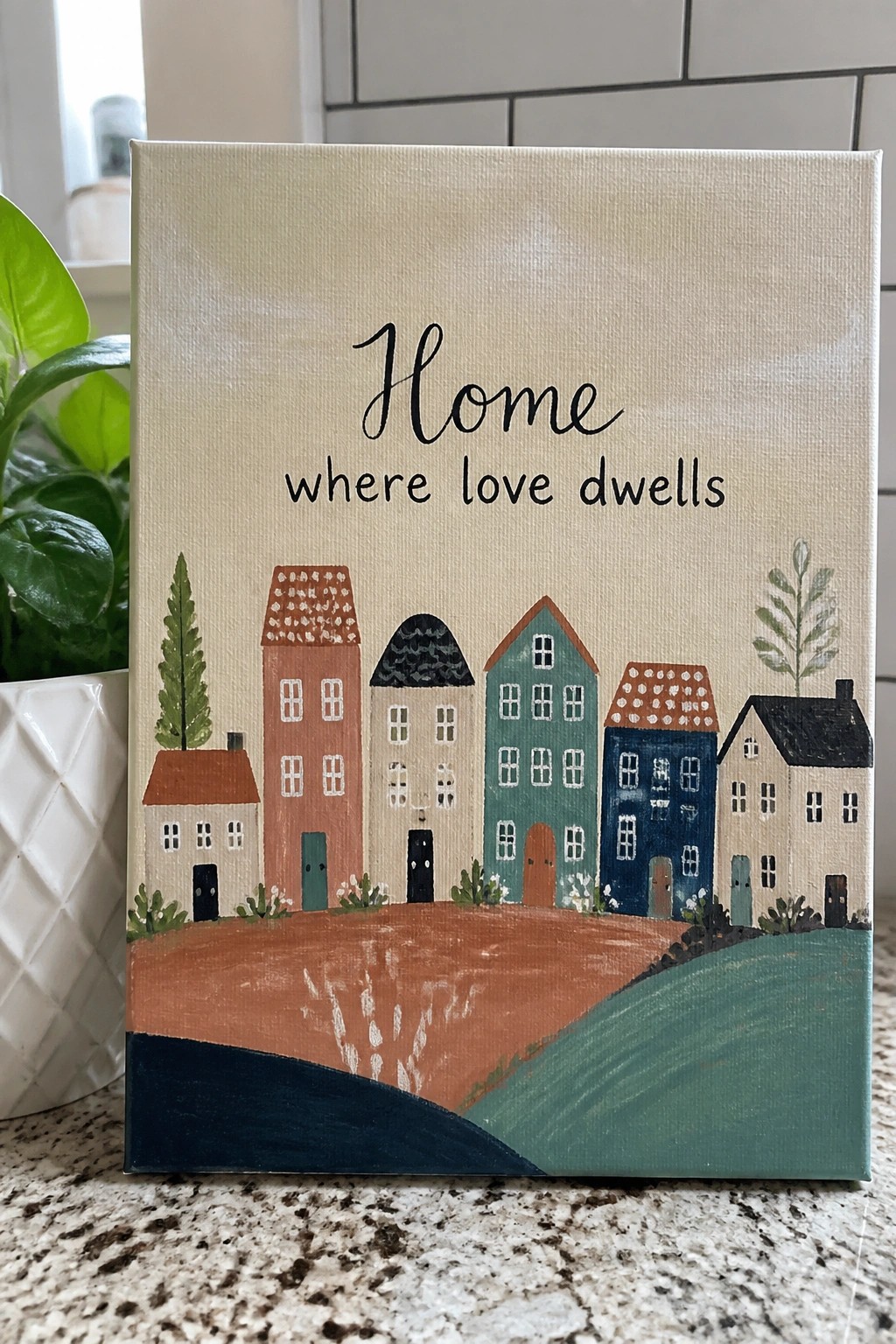Hand-painted canvas with colorful village houses and 