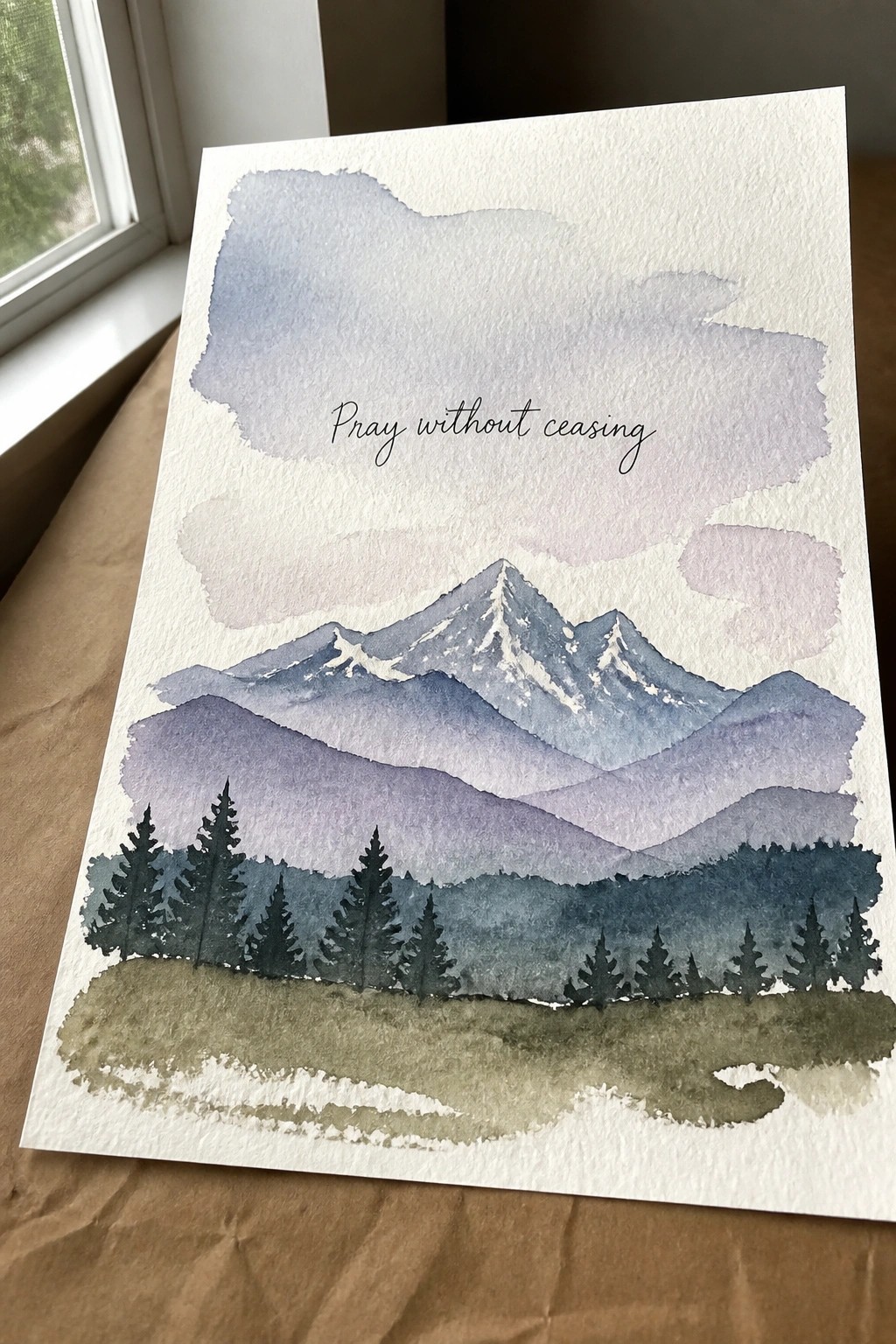 Watercolor mountain landscape with pine trees, grassy field, and 