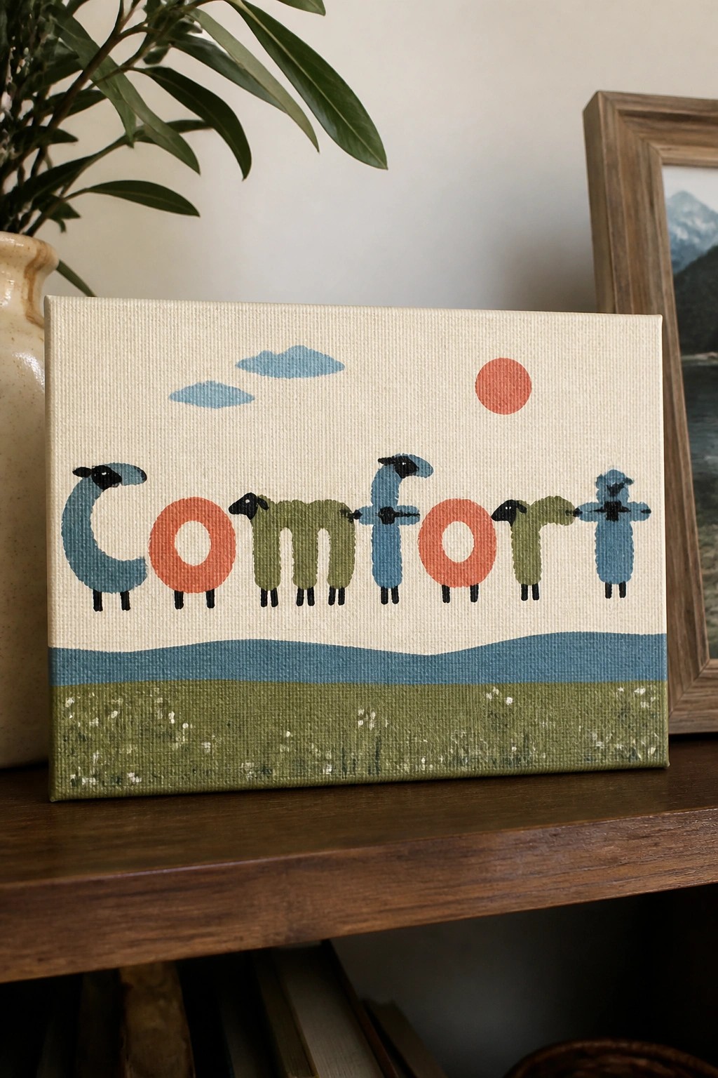 Canvas with word Comfort spelled by colorful sheep under red sun