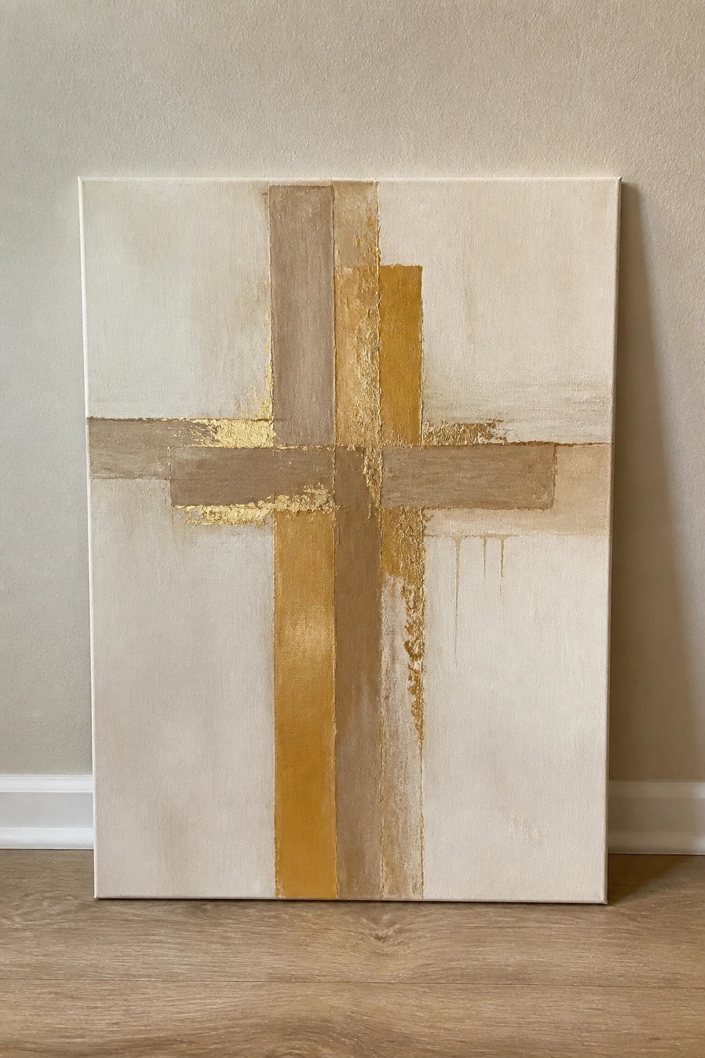 Abstract cross painting in gold, beige, and cream tones with gold leaf accents