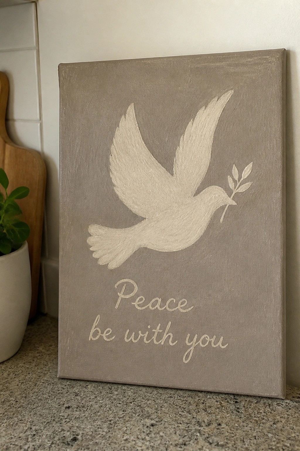 Gray canvas painting of white dove with olive branch above 