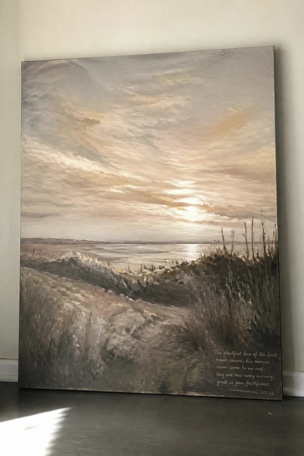 Large landscape painting of sunset over water with rocky path and Bible verse text