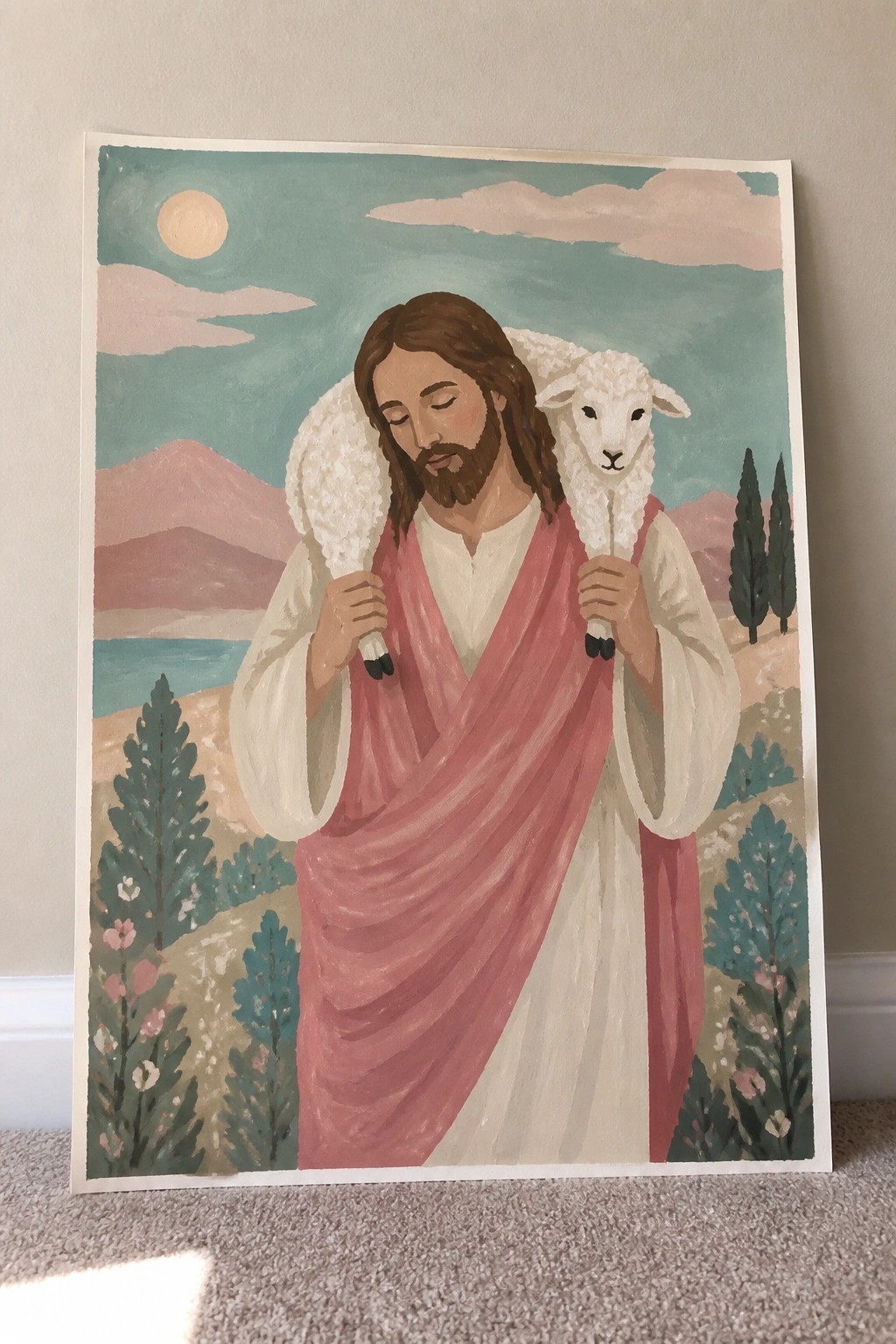Jesus in pink and white robes carries a white lamb amid mountains, lake and trees.