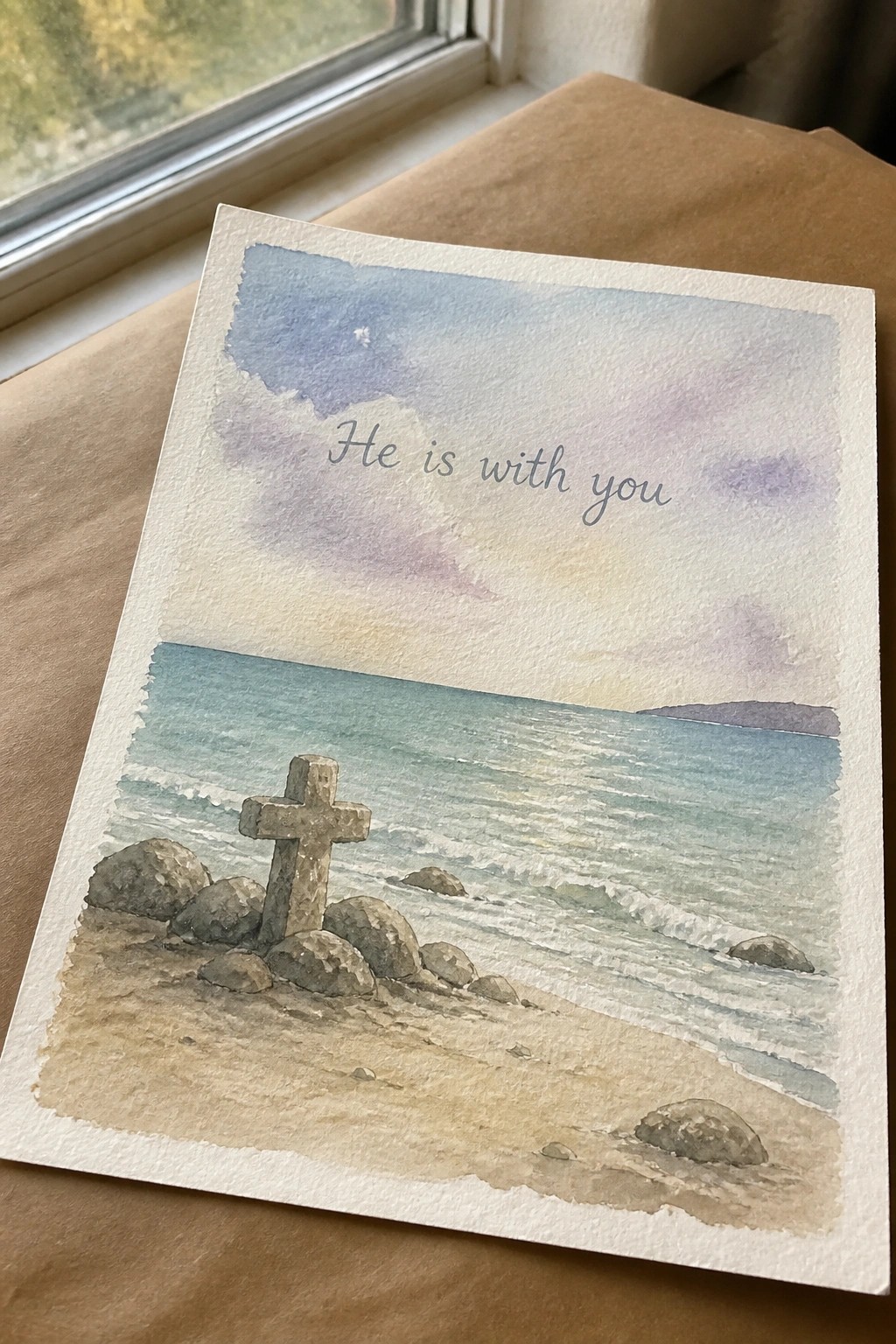 Watercolor card of stone cross on rocky beach with ocean waves and 