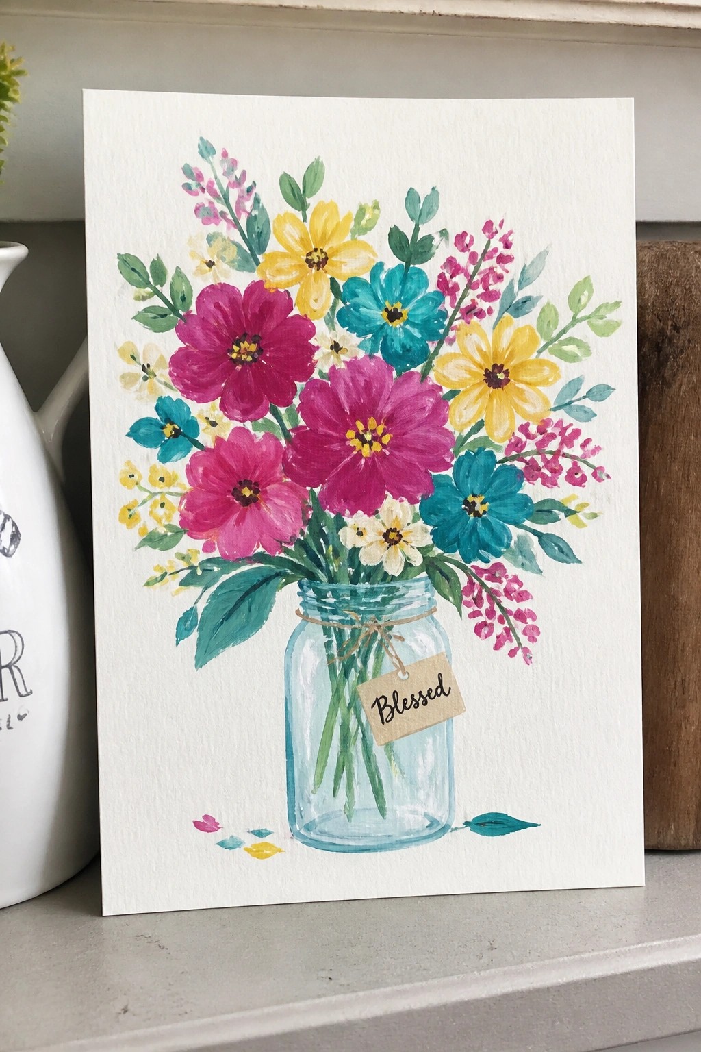 Watercolor bouquet of pink, yellow, and teal flowers in blue mason jar with 