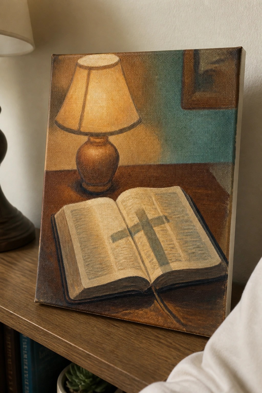 Still life painting of open Bible with cross beside glowing lamp on wooden table