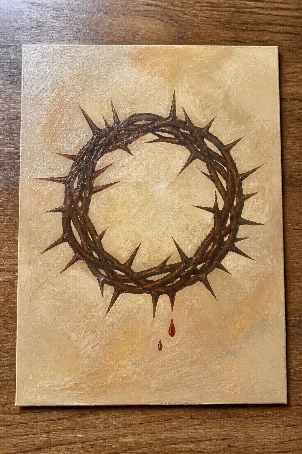 Brown crown of thorns with red blood drops on textured beige canvas