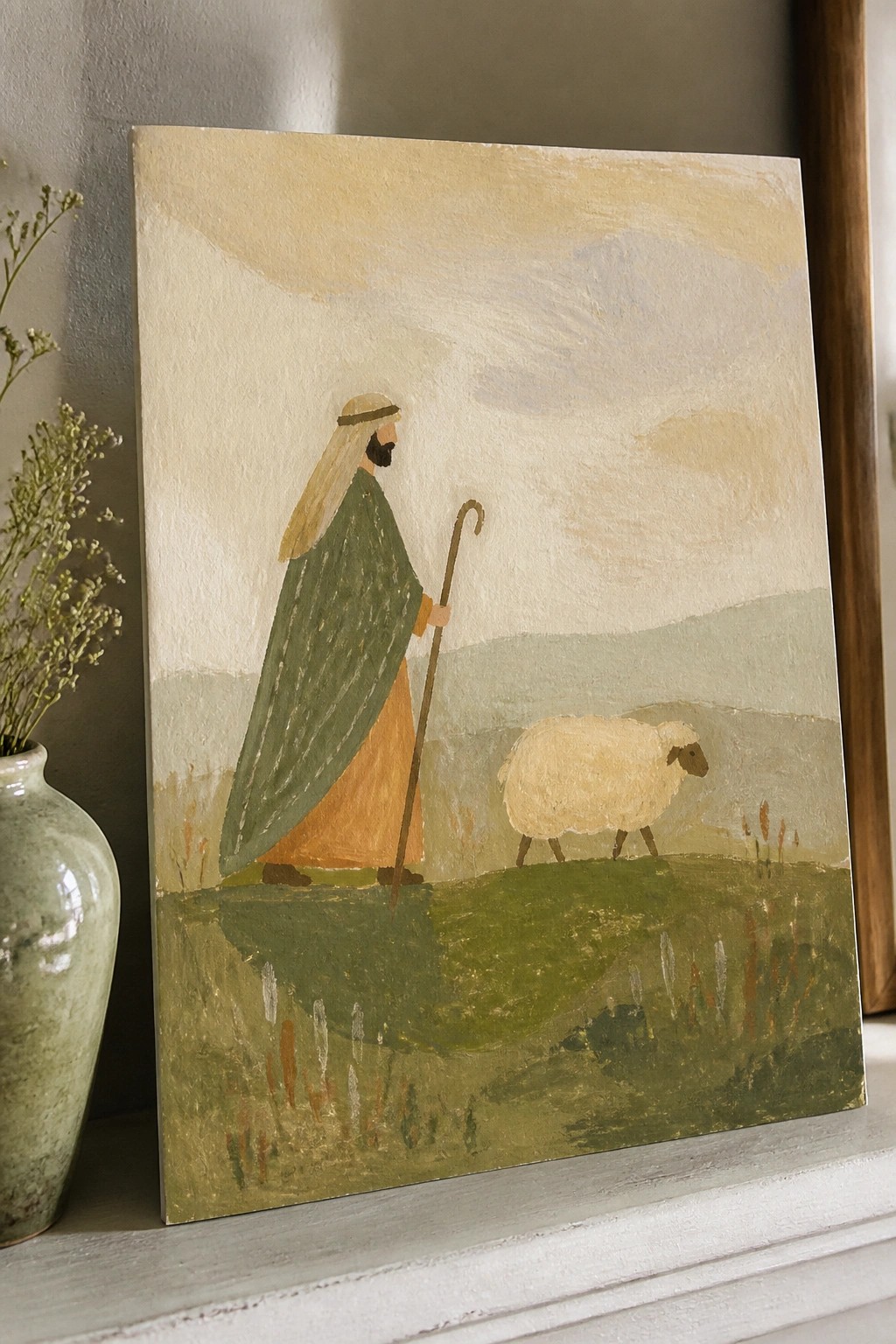 Pastoral painting of bearded shepherd in green cloak holding staff beside white sheep on hill