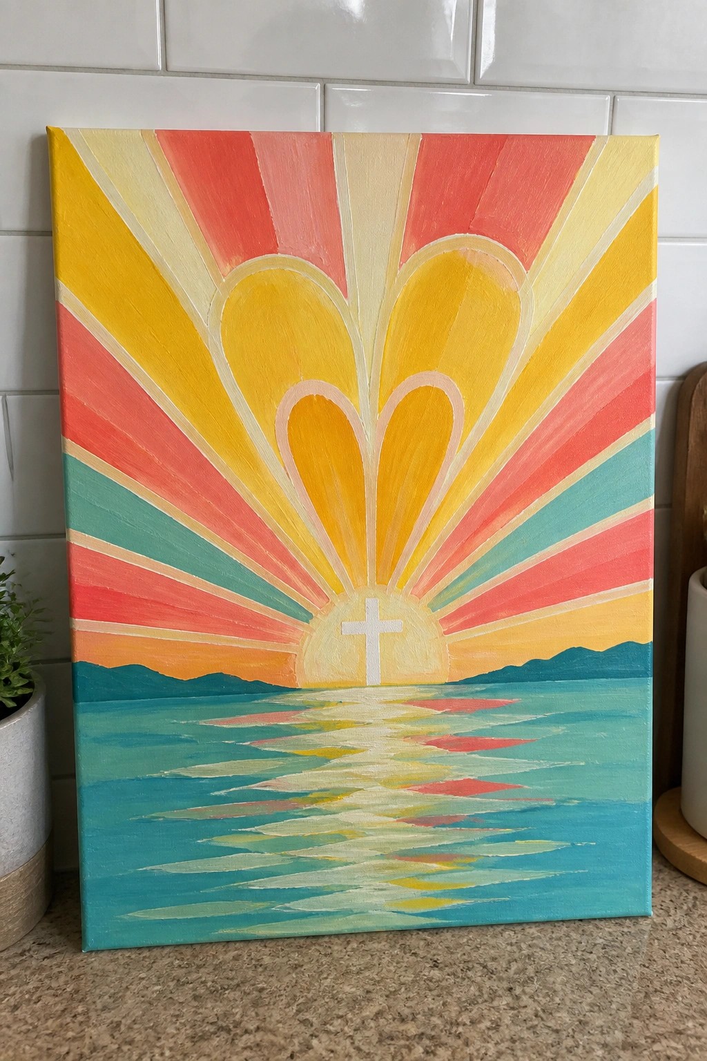 Vibrant painting of sunset rays forming hearts, white cross, and water reflection.