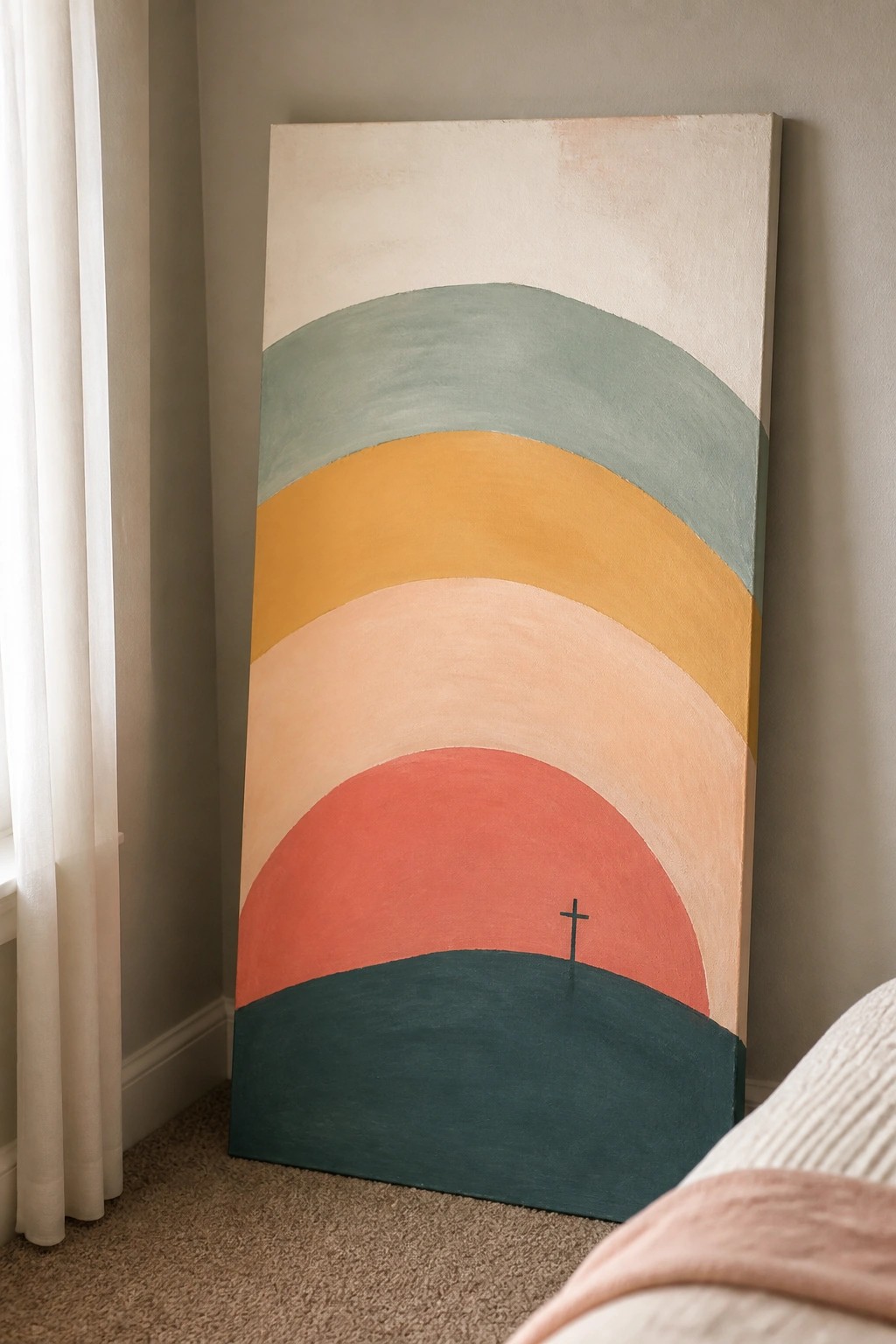 Abstract painting with curved earth-tone stripes and a small cross leaning on a wall