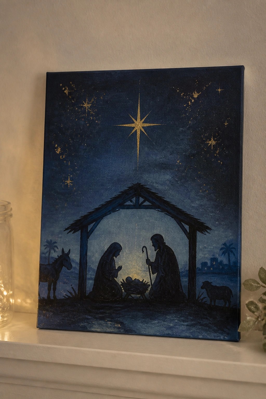Nativity painting with silhouetted Mary, Joseph, manger, donkey and sheep under golden star.
