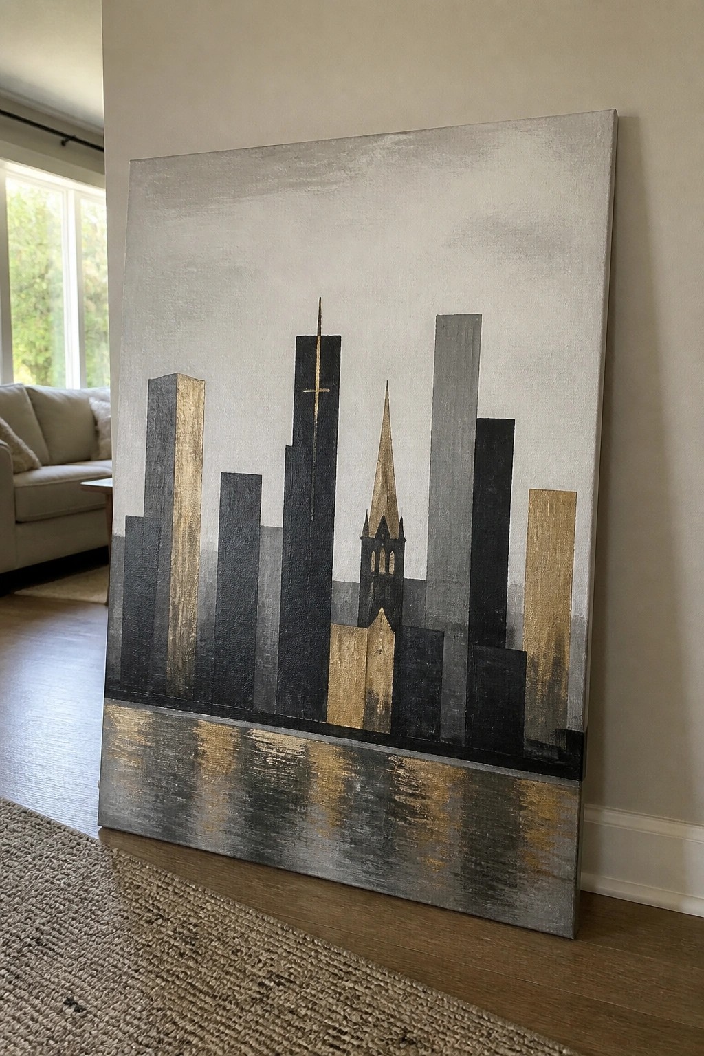 Abstract city skyline painting in black, gray, and gold with reflections, indoors