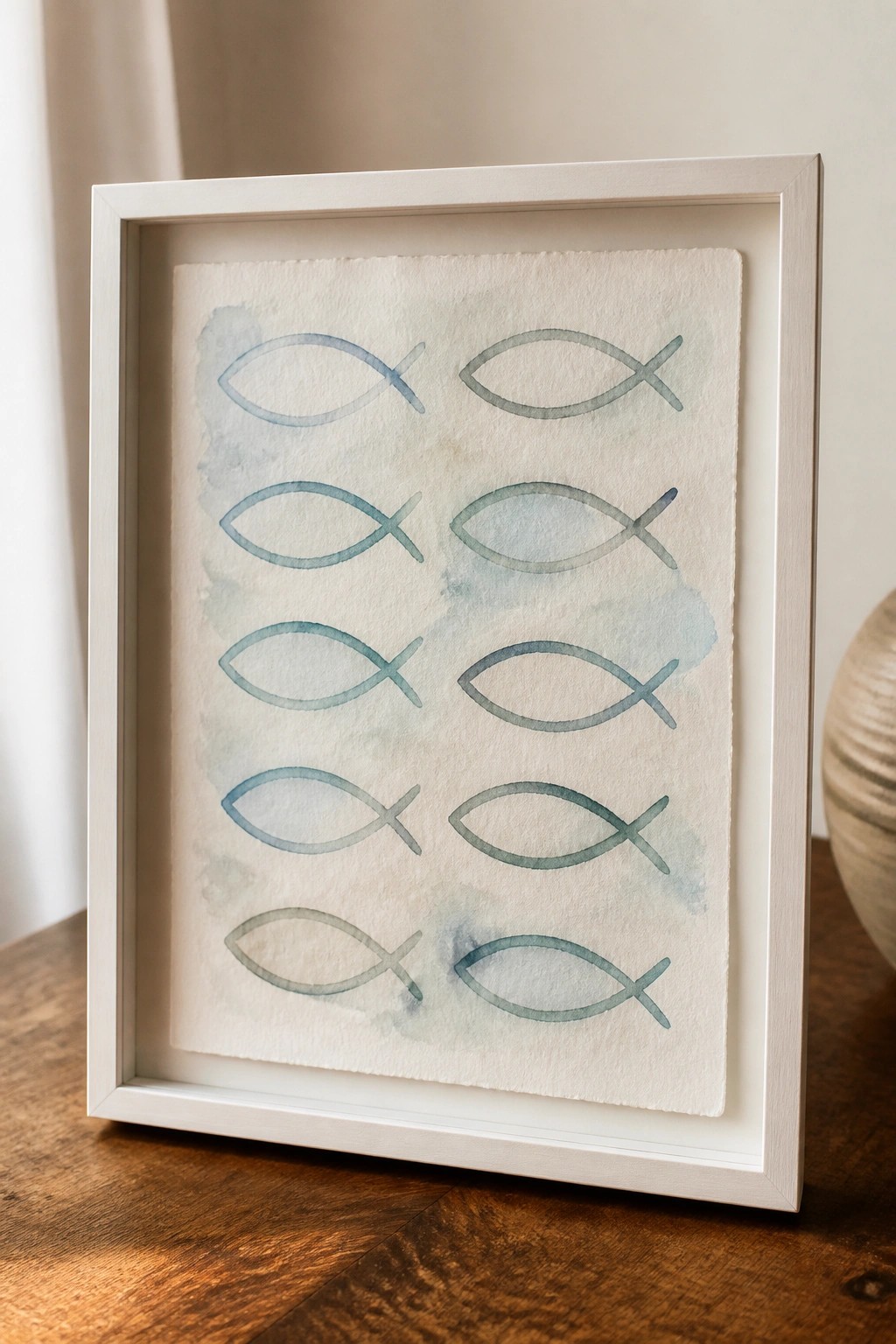 A framed artwork with ten blue-green fish symbols arranged in two columns on textured paper with soft watercolor washes.