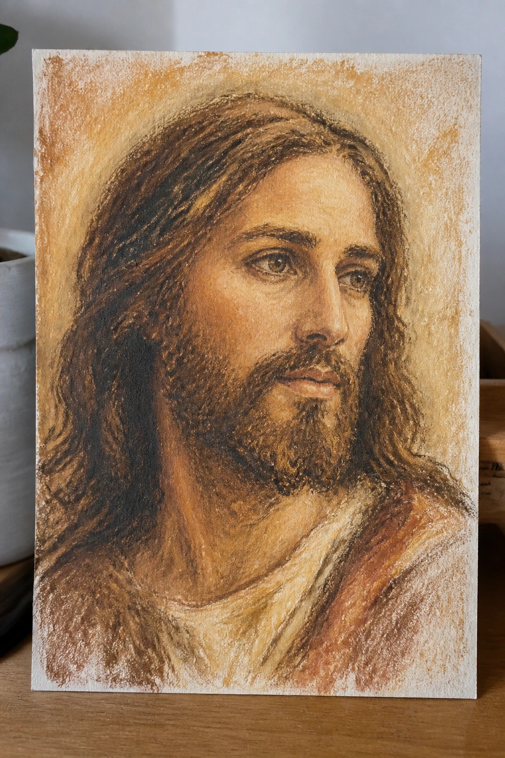 Realistic painting of Jesus with long brown hair, beard, and white-brown robe.