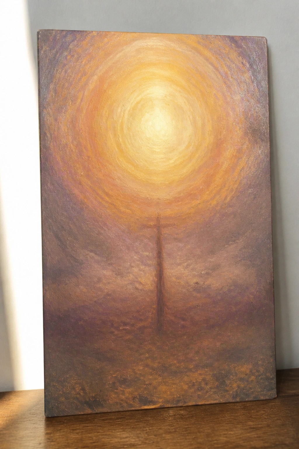 Swirling golden sun over silhouetted utility pole in textured earthy landscape