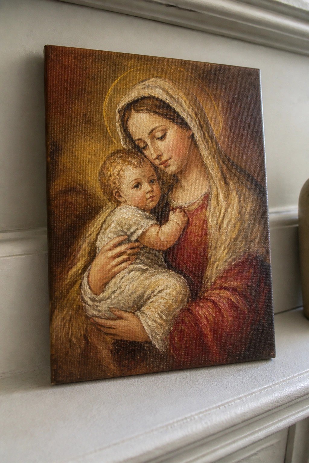 Oil painting of haloed woman in red holding baby on white ledge