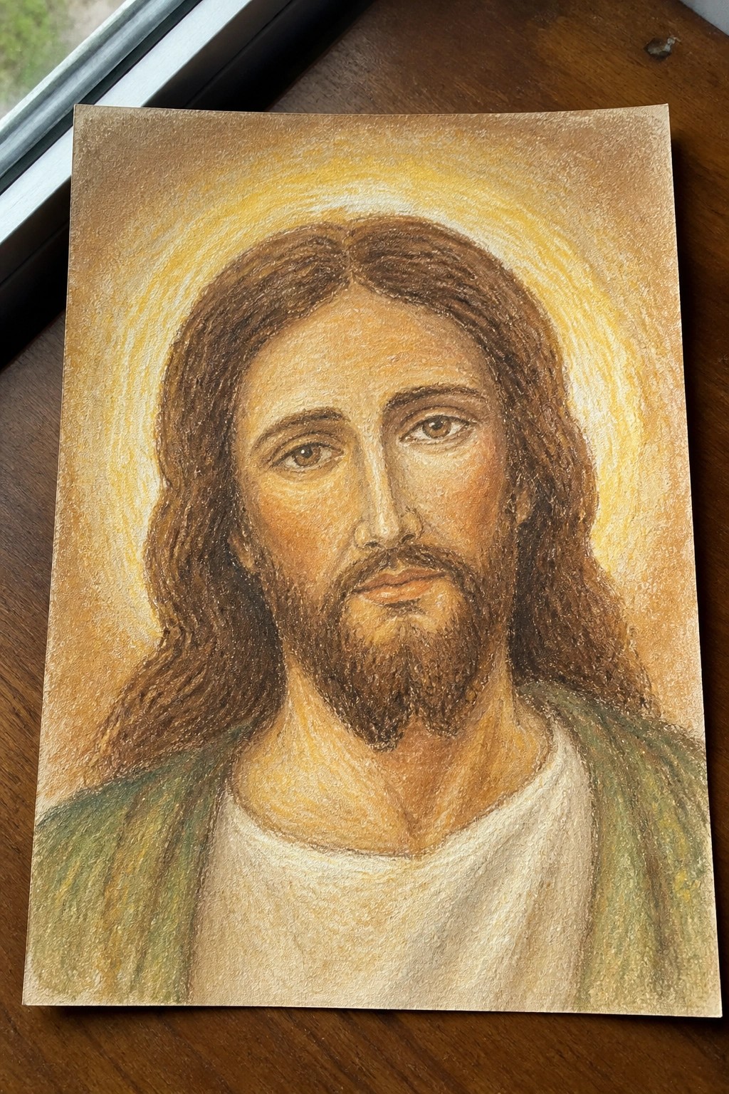Bearded man with long brown hair in white robe and green garment under golden halo.