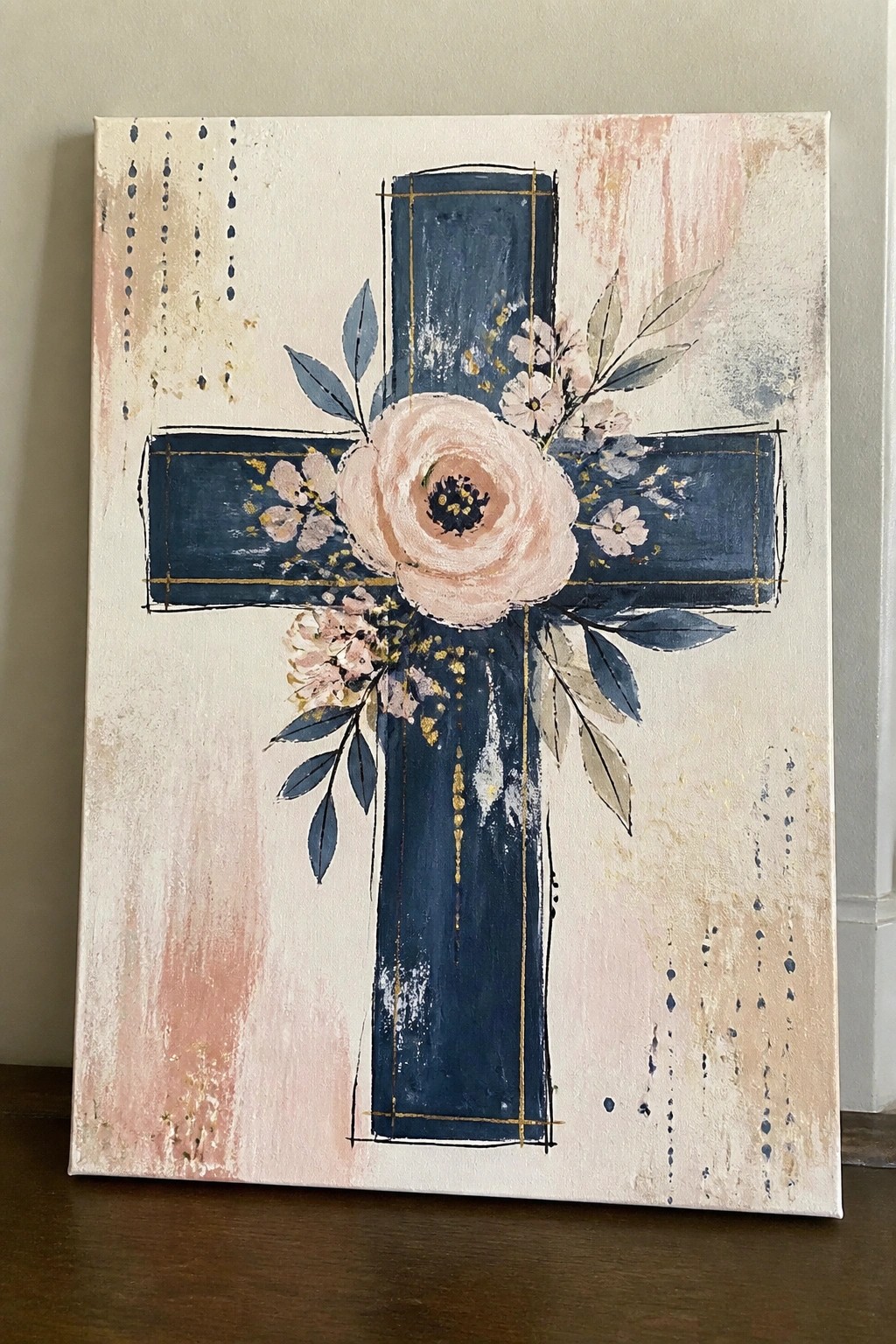 Blue cross with gold lines, pink flowers, and leaves on abstract beige background