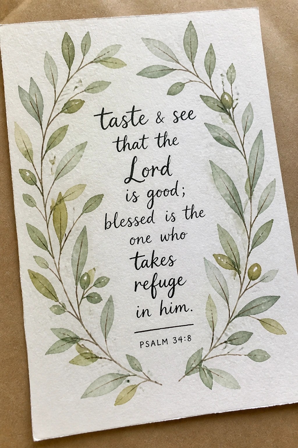 Watercolor green leaf wreath frames Psalm 34:8 text on white paper card
