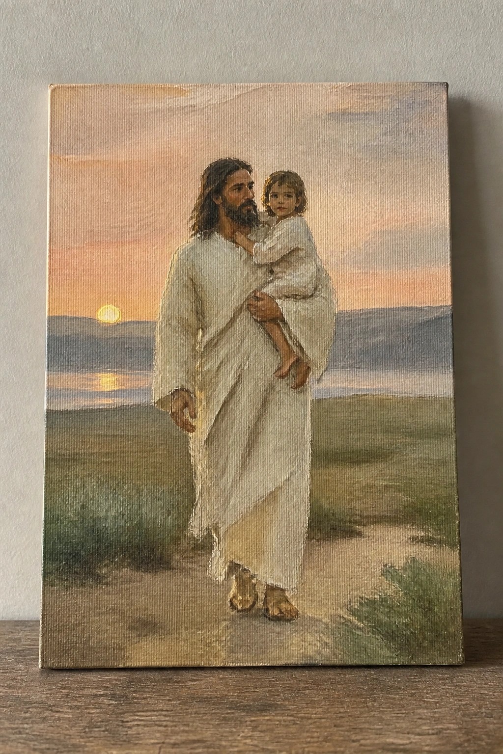 Oil painting of robed man carrying child on sunset path by water