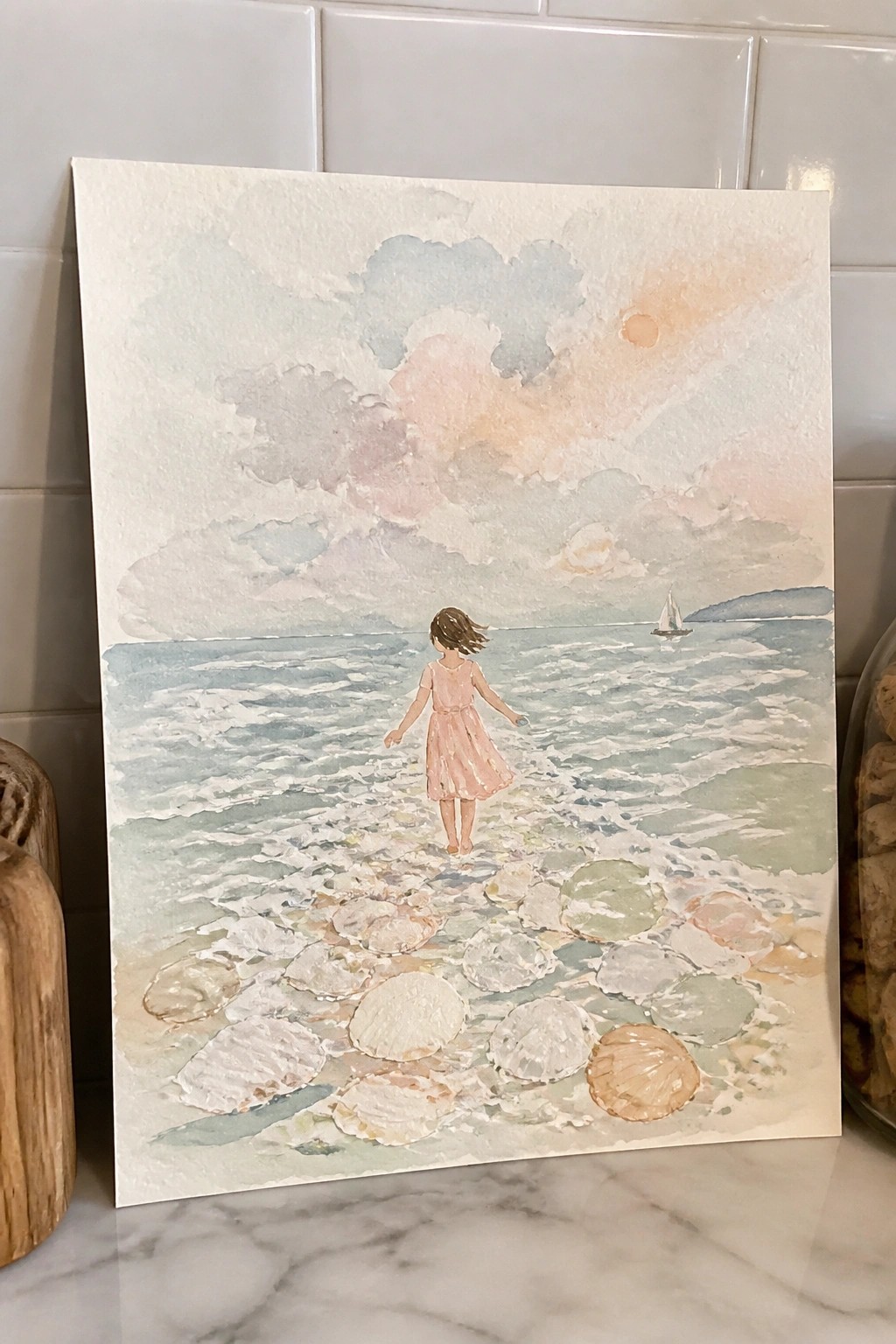 Girl in pink dress walks on colorful seashell beach toward sailboat in pastel watercolor ocean scene