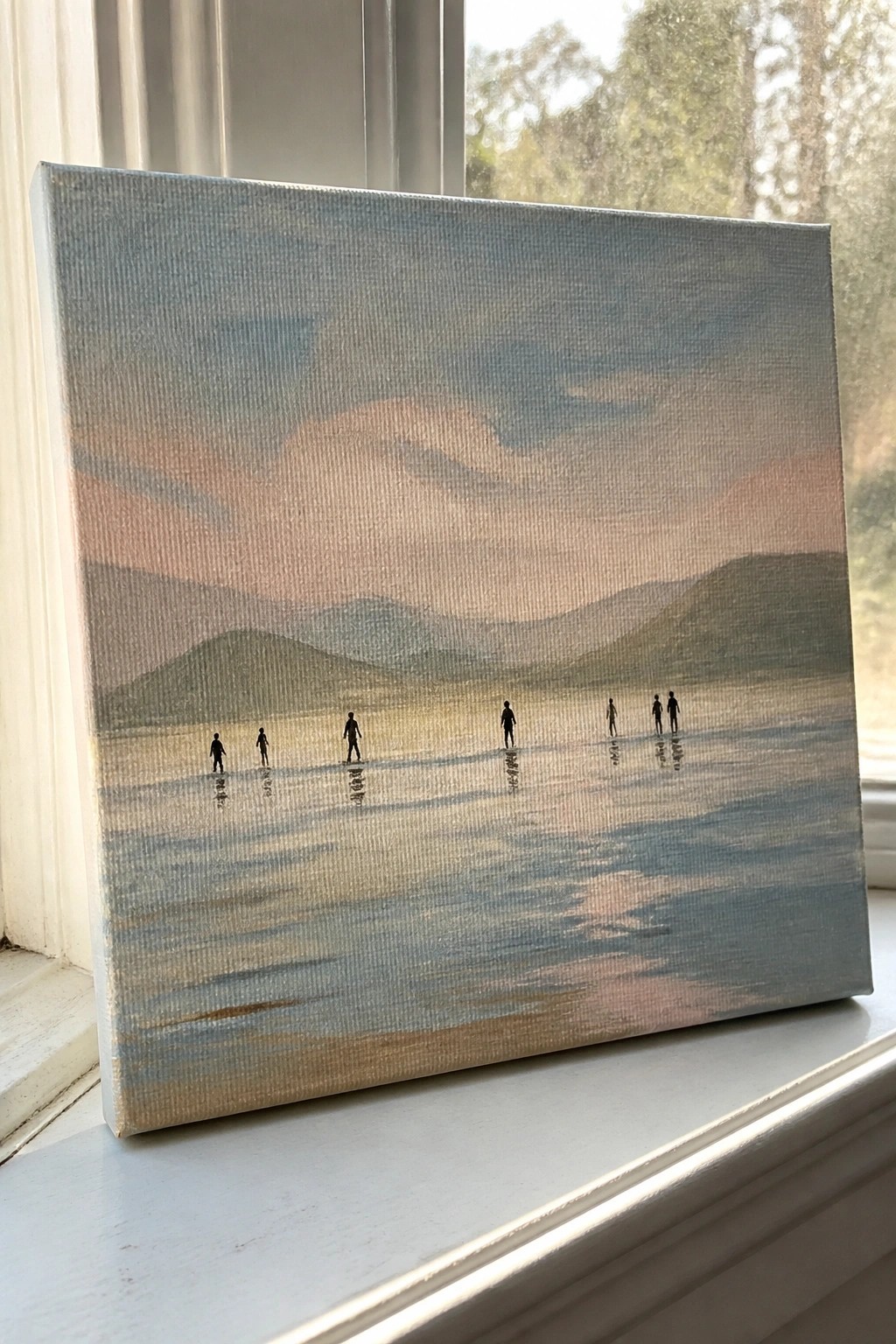 Canvas painting of silhouetted figures on reflective ground with misty mountains and soft clouds.
