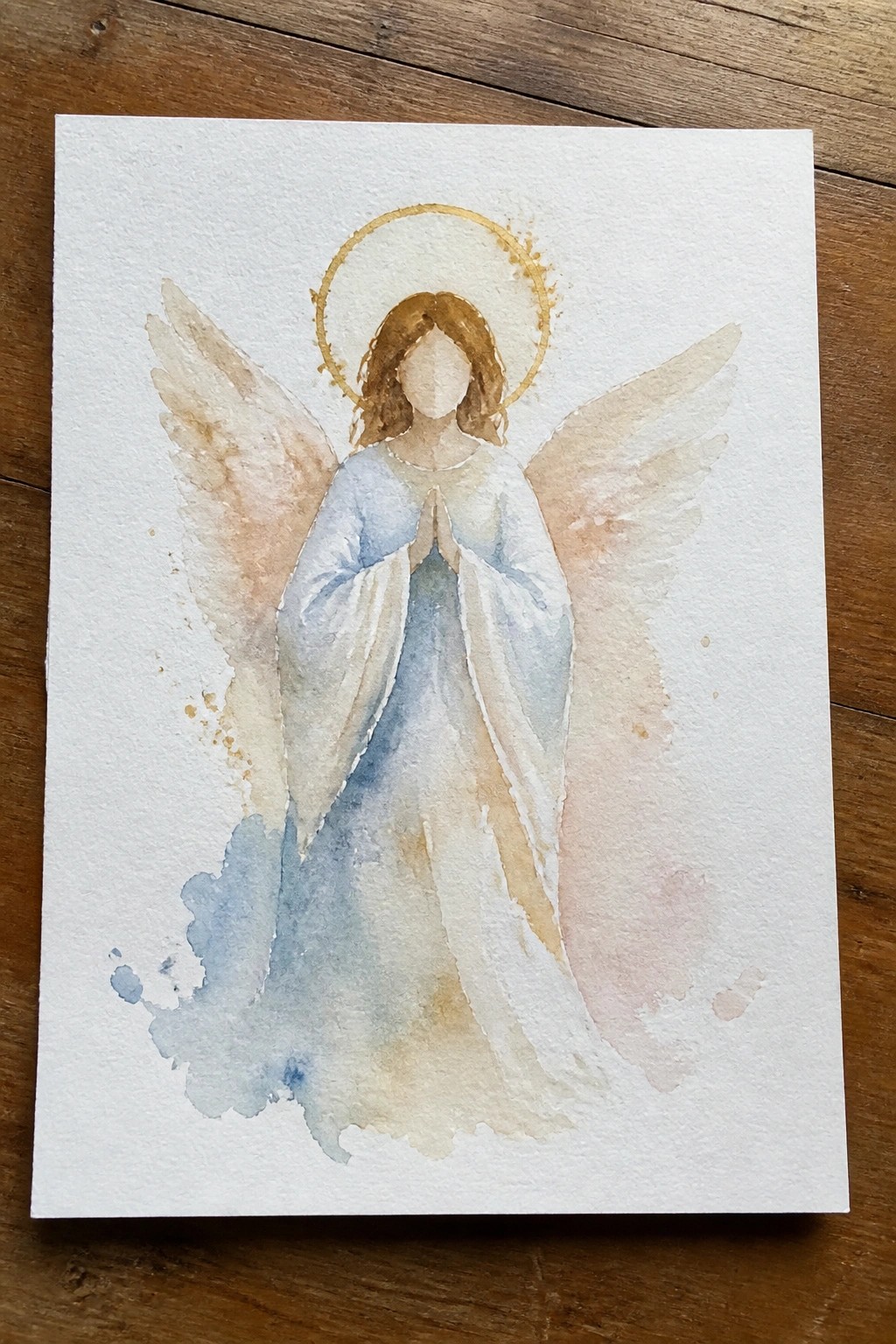 Watercolor angel with golden halo, brown hair, blue-white robes, and spread wings.