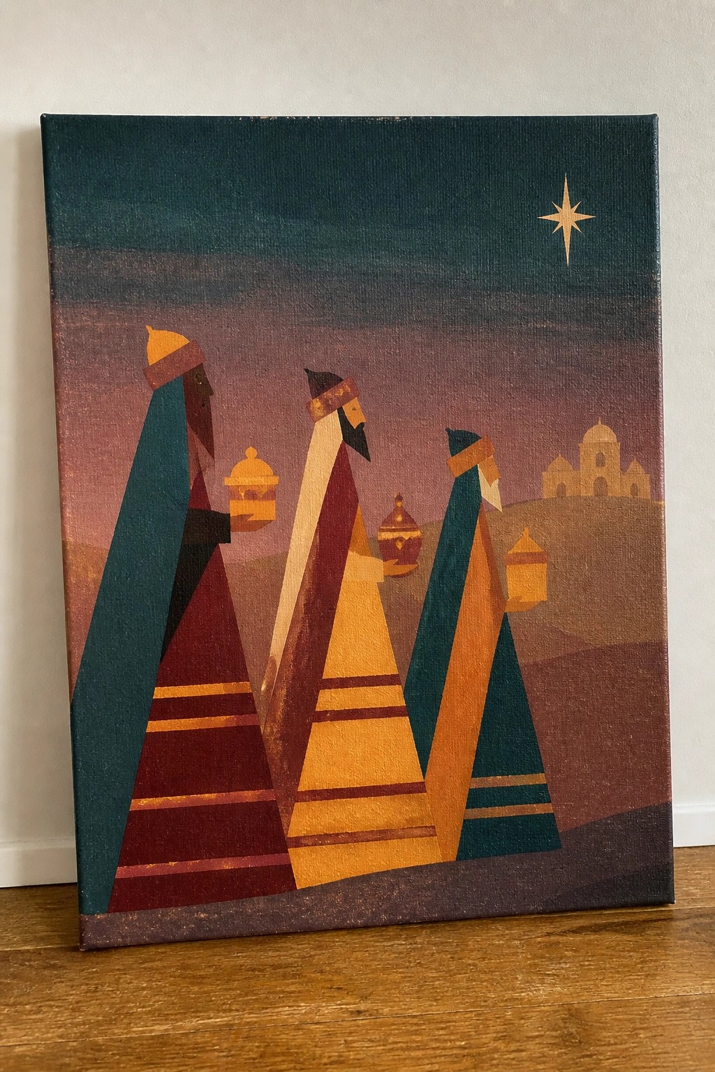 Three stylized wise men in robes carry lanterns under a bright star toward a city.
