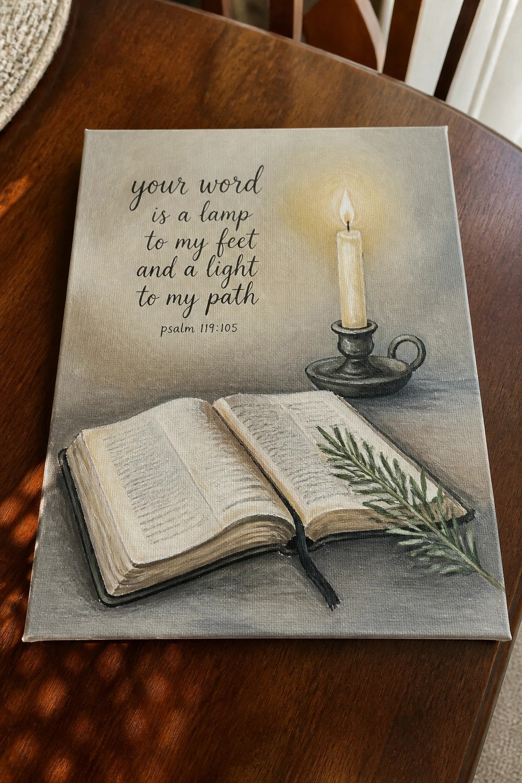 Canvas painting of open book, lit candle, greenery, and Psalm verse on wood table