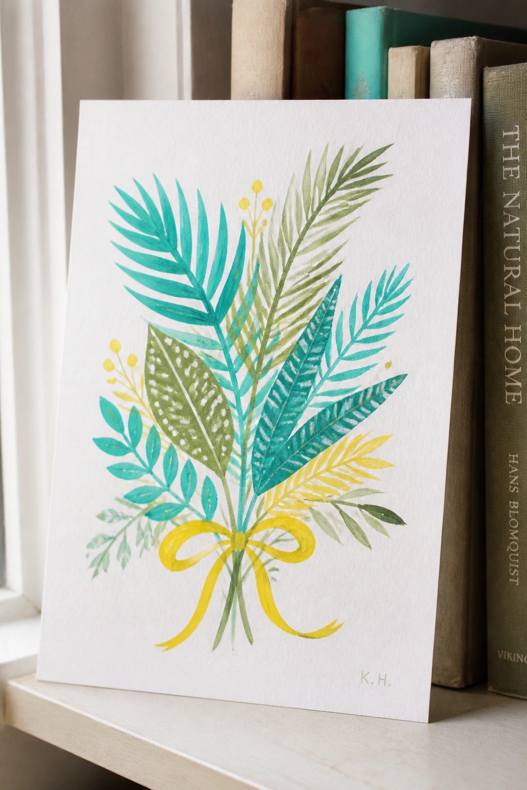 Watercolor bouquet of teal green leaves with yellow ribbon bow on white card