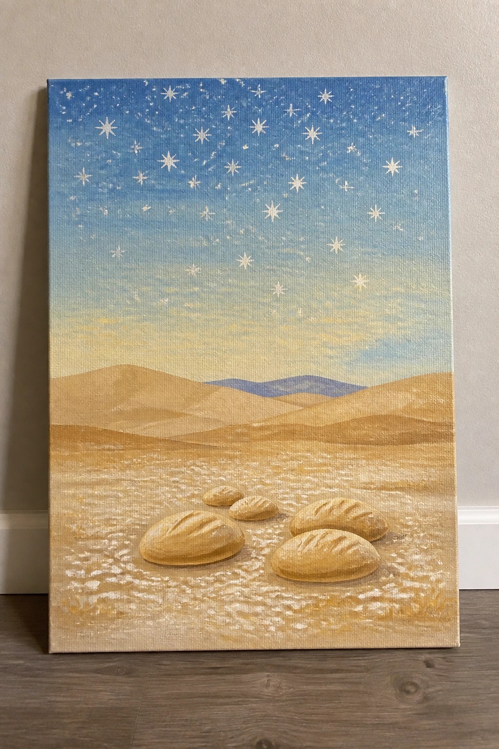 Bread loaves scattered on sandy desert under starry blue sky with distant hills