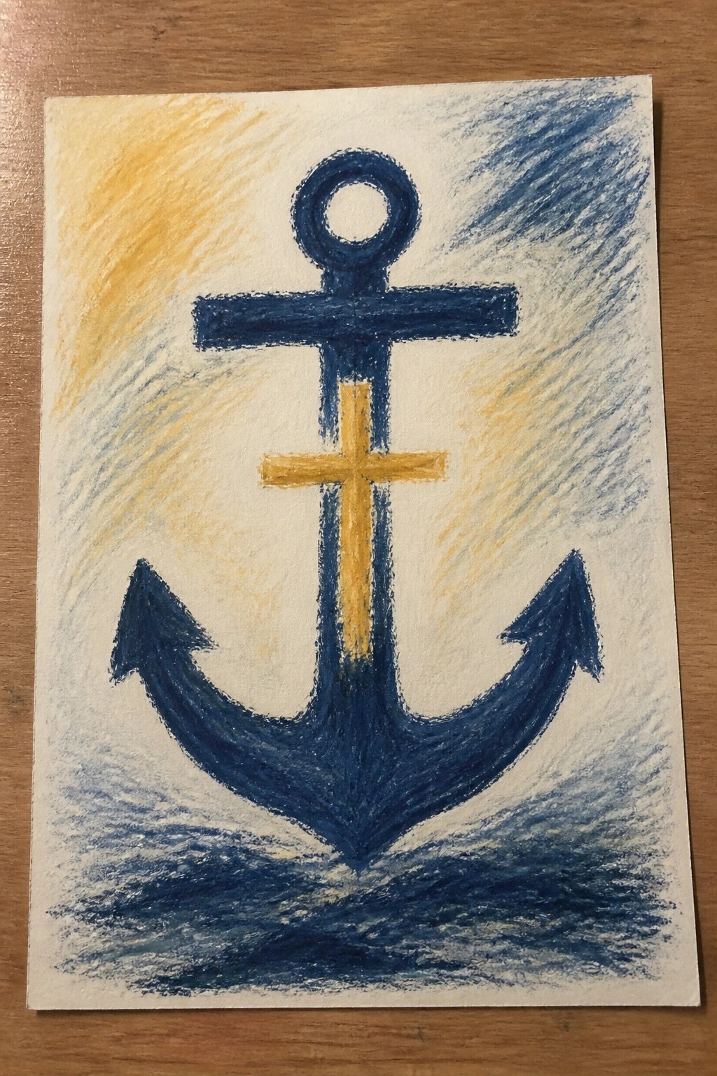 Blue anchor with yellow cross on white paper shaded in blue and yellow
