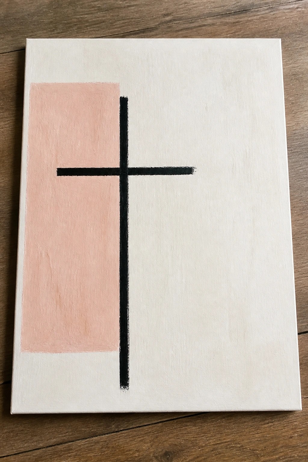 Minimalist canvas with pink rectangle and black cross on white background