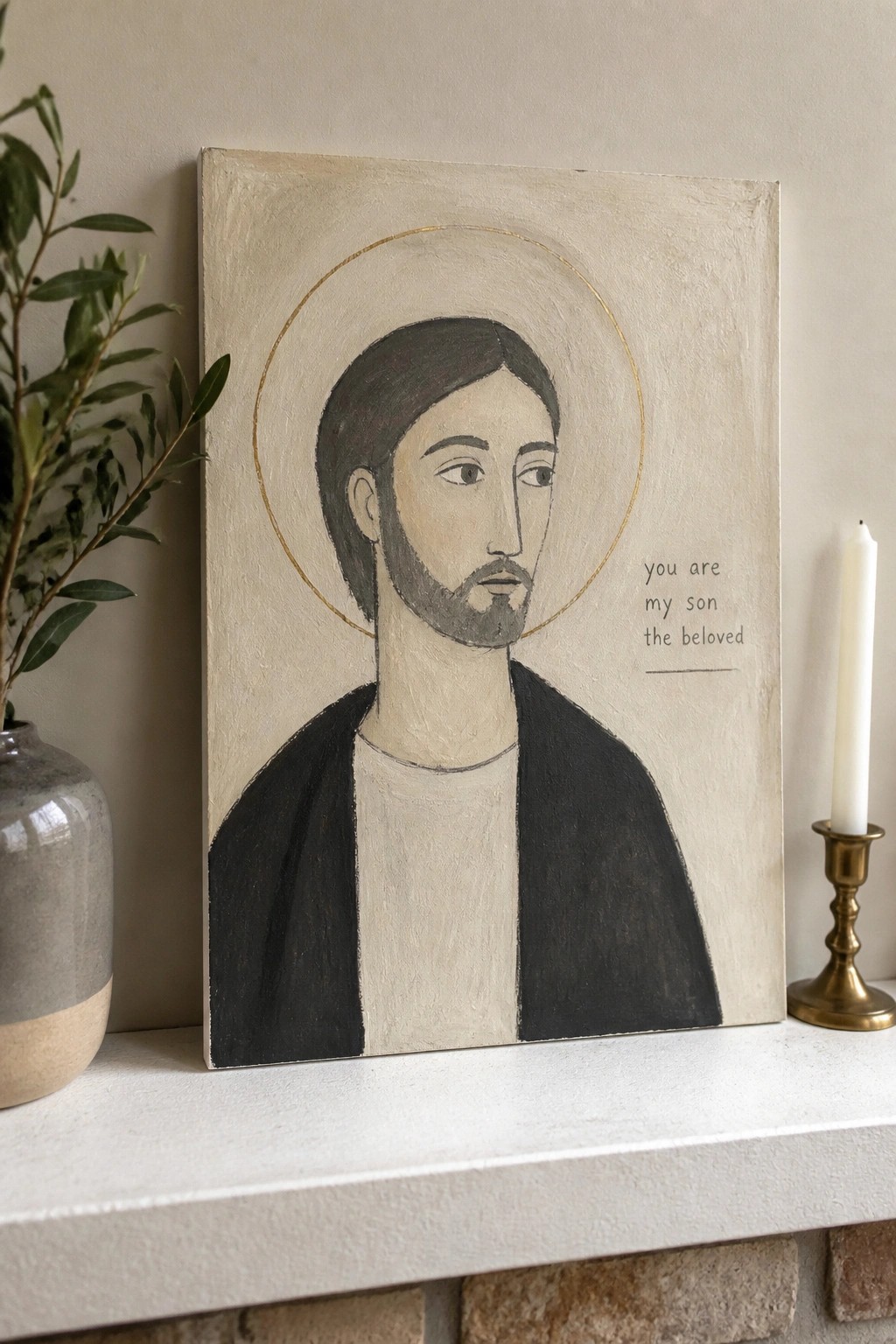 Modern painting of Jesus with gold halo and text beside plant and candle on mantel