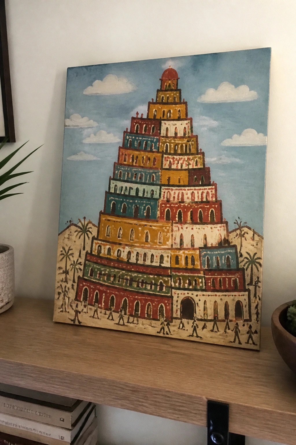 Colorful folk-art ziggurat painting with arched levels, palms, and tiny figures.