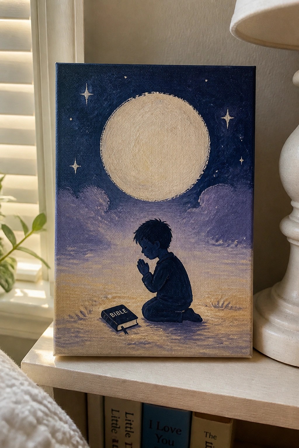 Child kneeling in prayer beside open Bible under full moon and starry night sky.