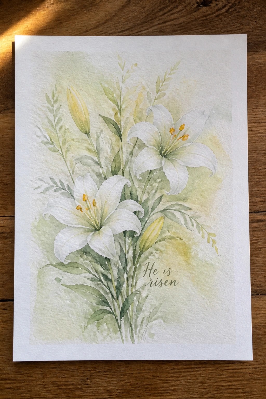 Watercolor of white lilies with yellow centers, green leaves, and 