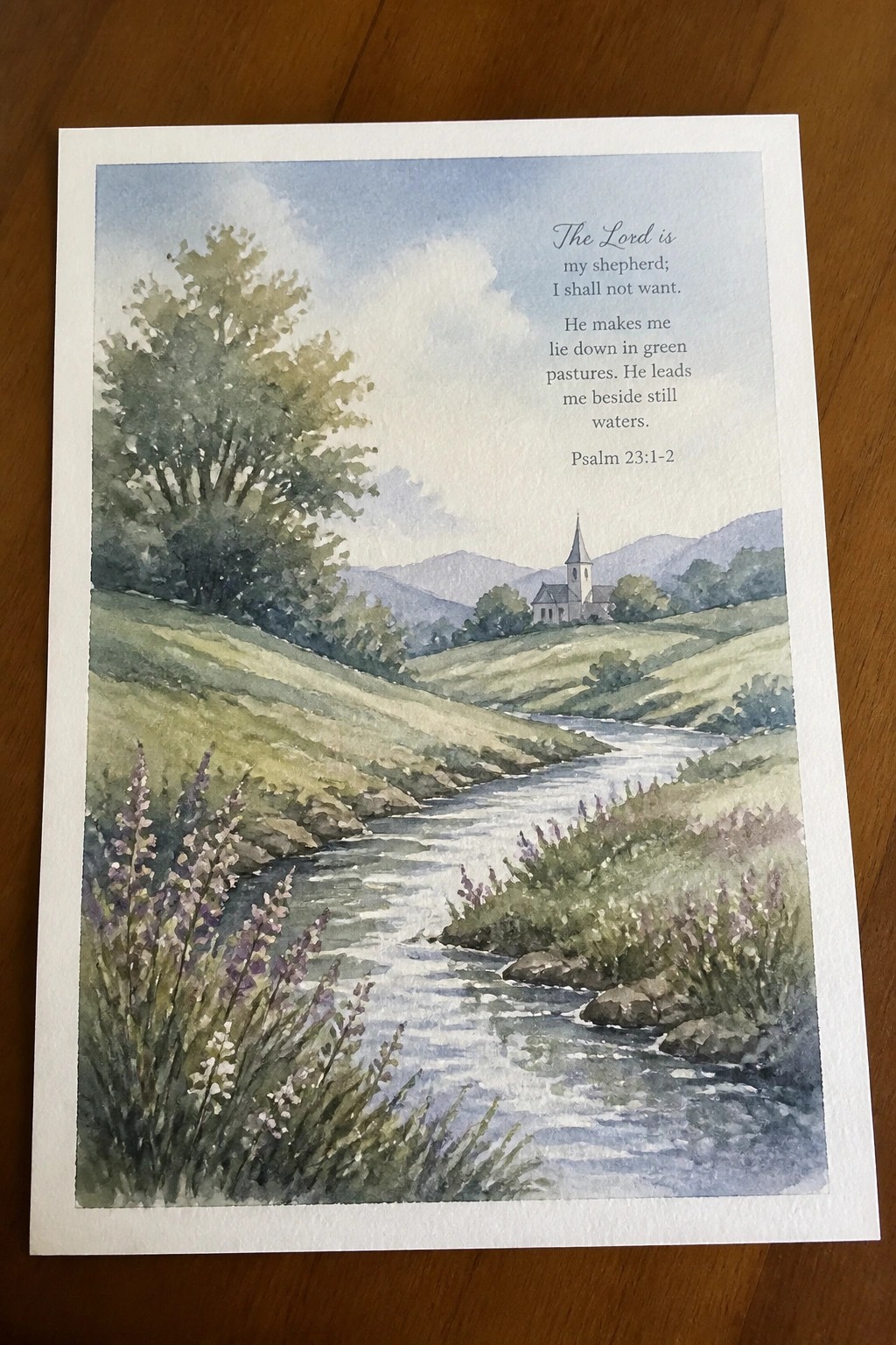 Watercolor of winding stream through green hills with flowers, church, and Psalm 23 text