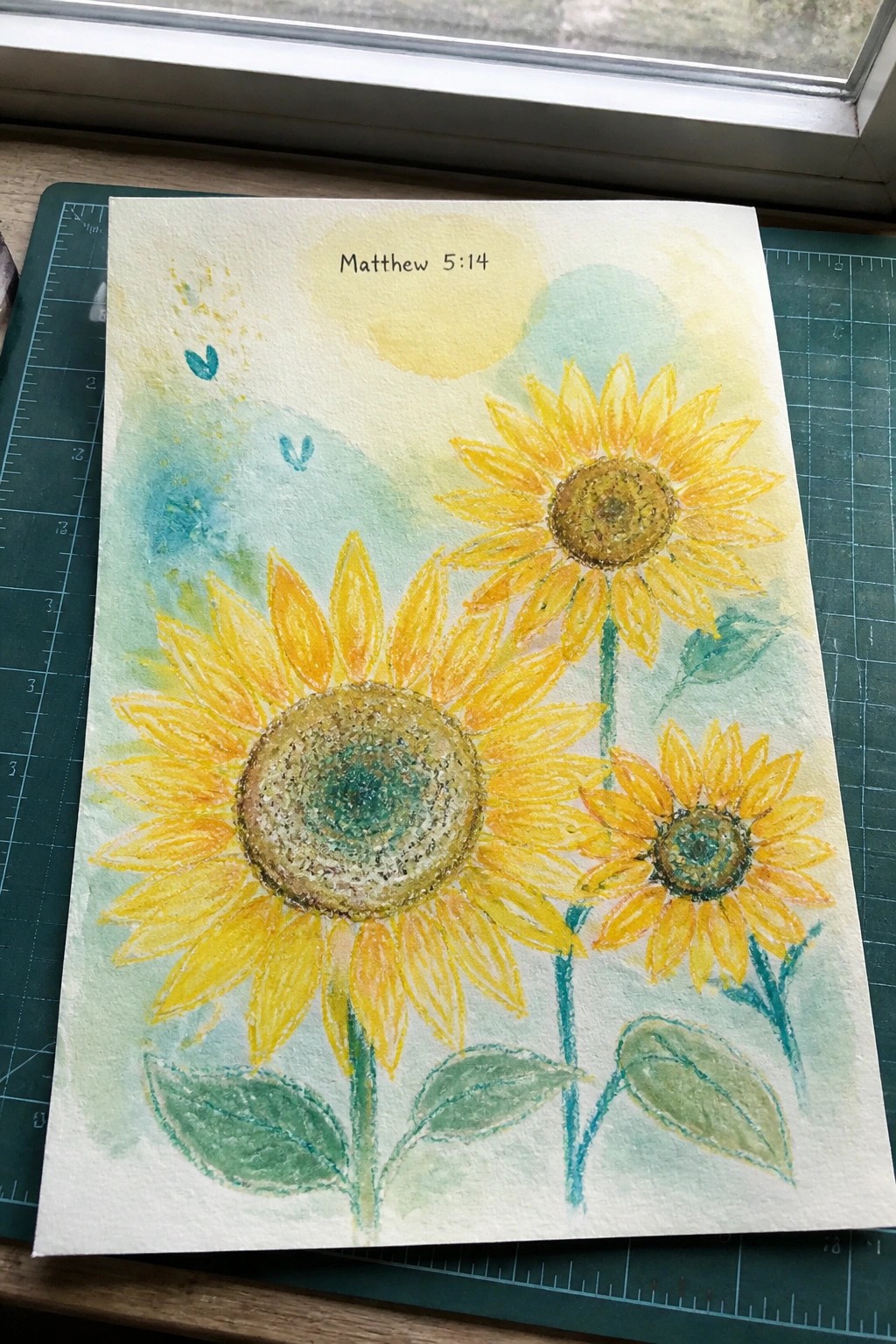 Watercolor painting of three yellow sunflowers with Matthew 5:14 text above