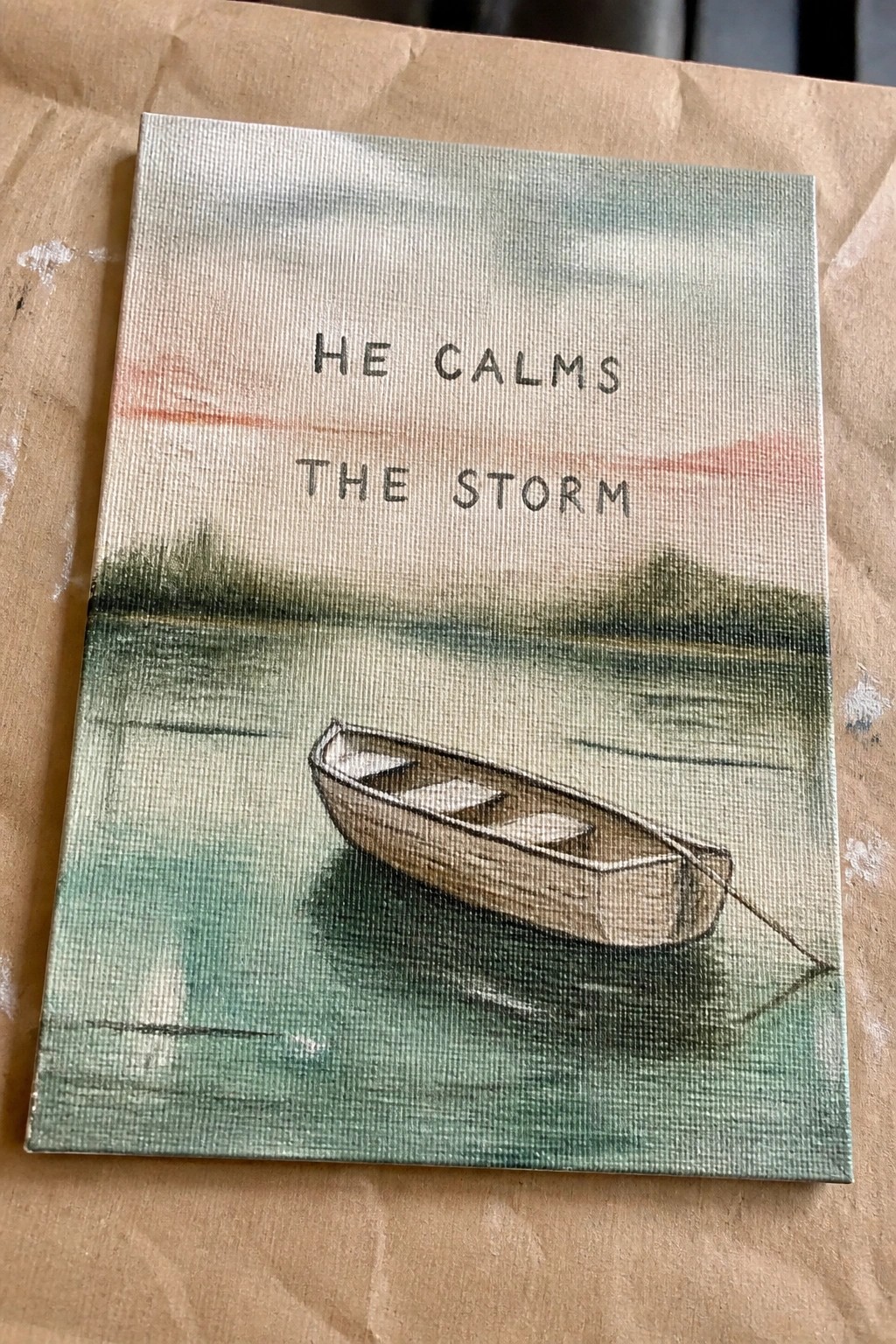 Canvas painting of rowboat on calm water beneath 